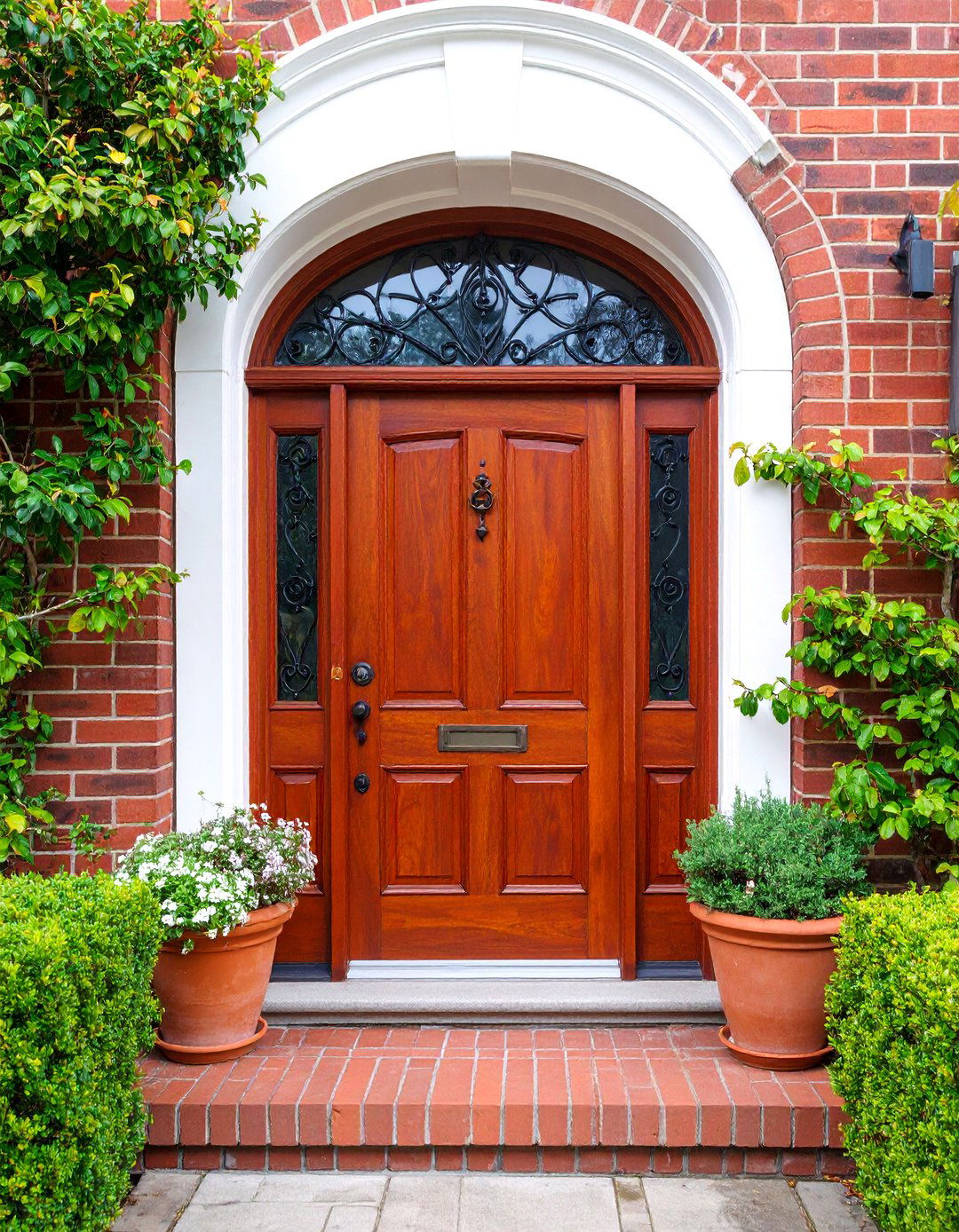 Arched Mahogany Door with Wrought Iron Speakeasy - 25 Mediterranean Front Door Ideas