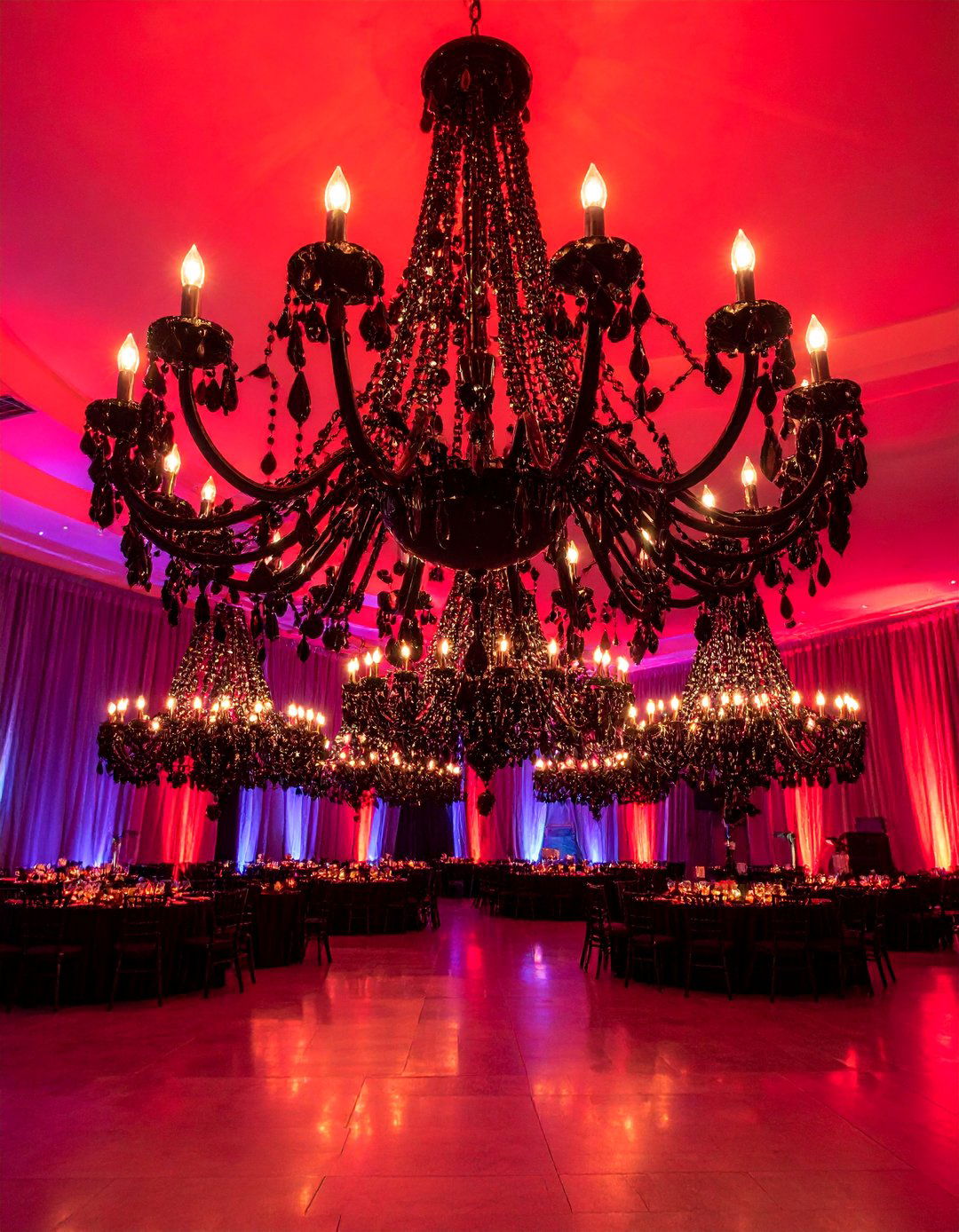 Black Chandelier Reception with Red Lighting - 25 Red and Black Wedding Ideas
