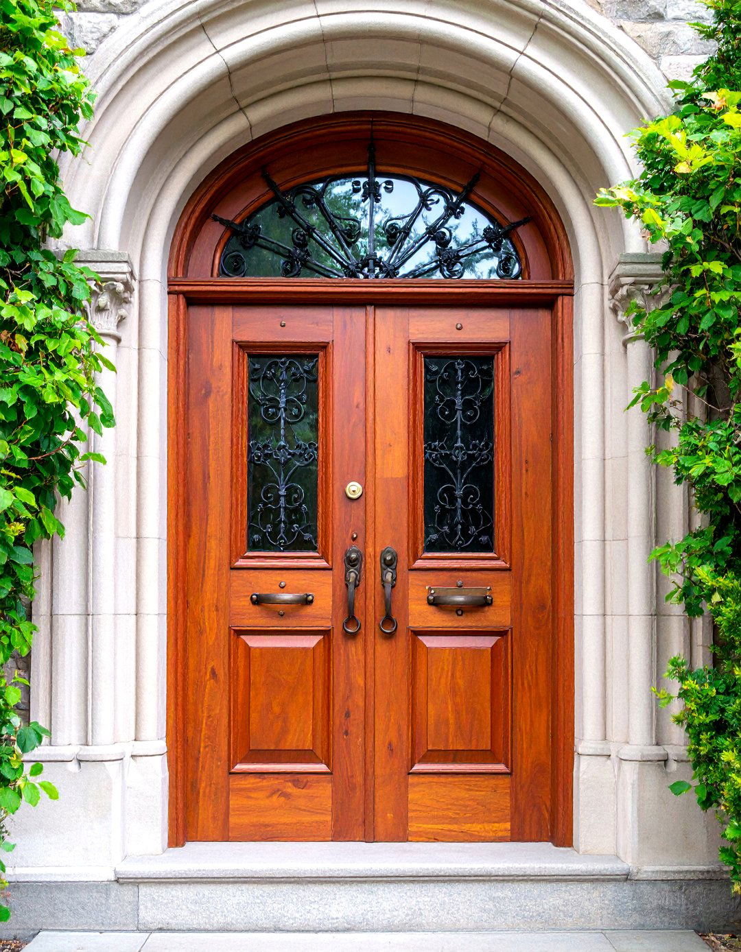 Gothic Arched Mahogany Door with Wrought Iron Grille - 25 Gothic Front Door Ideas