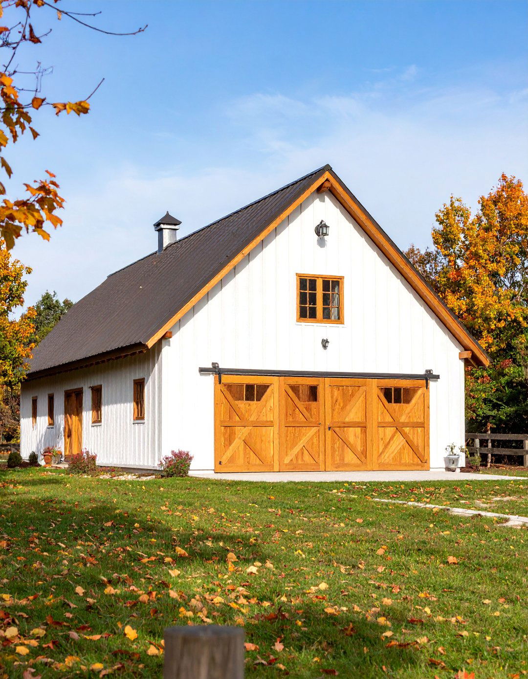 White Barndominium with Natural Wood Elements - 25 Barn House Exterior Ideas